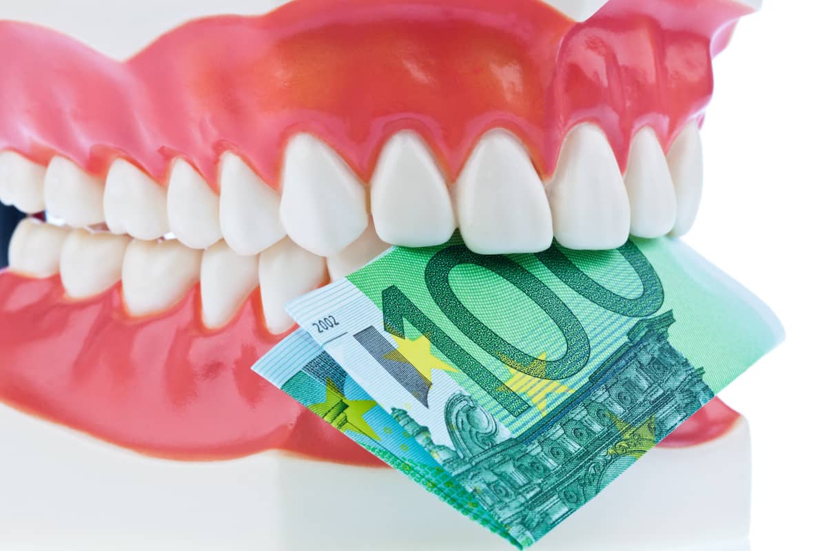 Gebiss mit 100 Euro schein zwischen den Zähnen